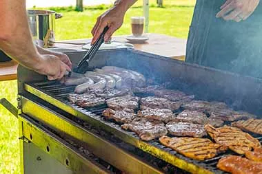 Grilled food on a large grill in the garden of the itelio GmbH headquarters.